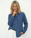 FJØRNA linen blend women's shirt, stylish and lightweight top with a relaxed fit, worn by a female model.