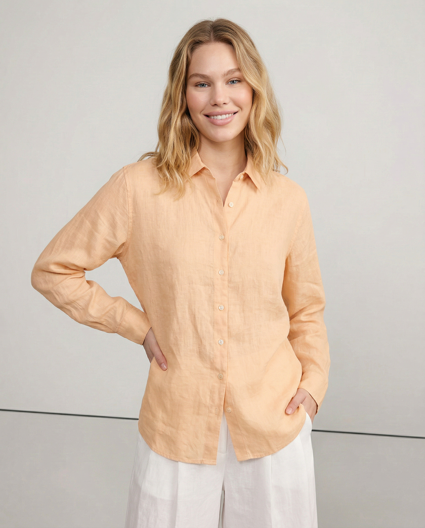 Women’s linen V-neck shirt by FJØRNA, featuring a relaxed fit, natural fabric, and casual style, worn by a model.