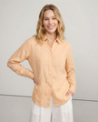 FJØRNA women's linen V-neck shirt, soft and breathable top, shown worn by a model in a casual outdoor setting.