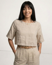 FJØRNA women's linen crop top with short sleeves, lightweight and stylish for casual wear, shown on a model.