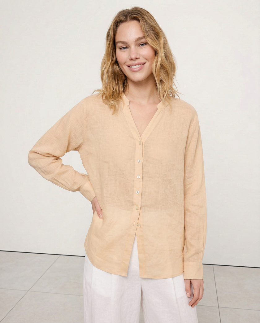 FJØRNA women's linen V-neck shirt, lightweight and breathable top, worn by a model with a relaxed fit and natural style.