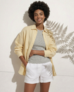 FJØRNA women's knit shirt with slit hem, featuring a cozy, fitted design and stylish side slit, worn by a female model.