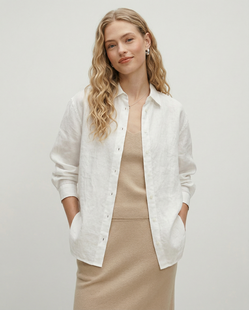 FJØRNA linen shirt with slit hem detail, shown on a model, featuring a relaxed fit and lightweight fabric perfect for casual wear.