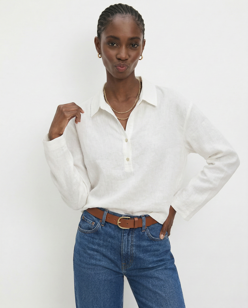 Women’s linen polo top by FJØRNA featuring a classic collar and relaxed fit, styled on a model in a casual setting.