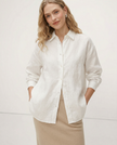 FJØRNA women's knit shirt with slit hem, showcasing a stylish, fitted top in a natural pose.