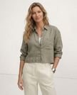 FJØRNA linen crop top for women with pleated long sleeves and a relaxed fit, shown on a model against a neutral background.