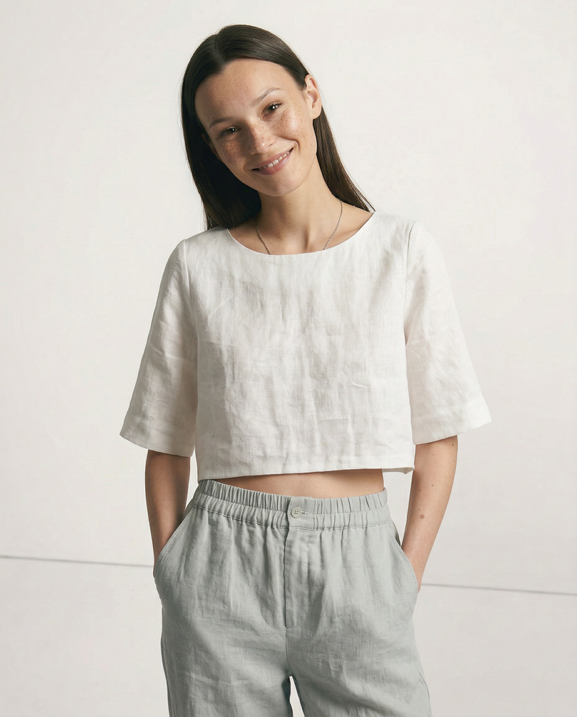 FJØRNA women's linen crop top with short sleeves, lightweight and breathable, worn by a model in a casual setting