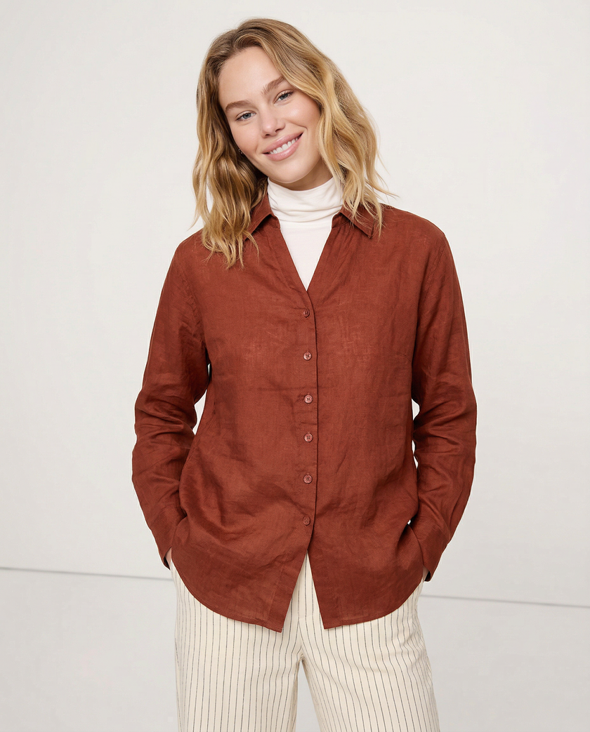 Women’s linen V-neck shirt by FJØRNA, lightweight and breathable, shown on a model in a casual setting.