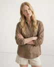 FJØRNA women’s linen shirt with open collar, lightweight and breathable fabric, modeled on a woman, showcasing fabric quality and fit.
