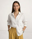 FJØRNA women's linen shirt with open collar, showcasing lightweight, textured fabric and relaxed fit on a model.