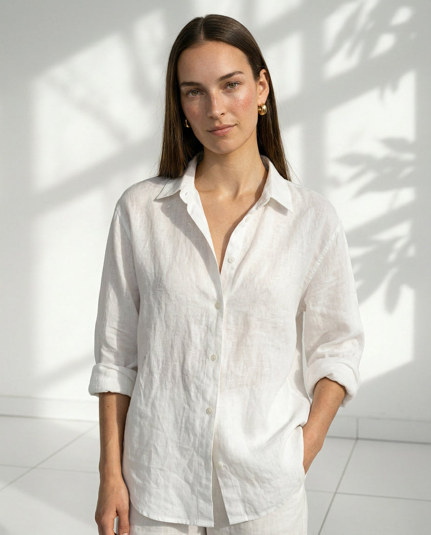 FJØRNA women’s linen shirt with open collar, lightweight and breathable fabric, worn by a model showcasing relaxed style.