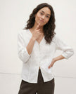FJØRNA tailored V-neck linen top on a model, showcasing high-quality lightweight linen fabric and a stylish, fitted design.