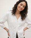 FJØRNA tailored v-neck linen top on a model, showcasing high-quality, breathable linen fabric and stylish design.