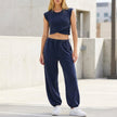 FJØRNA contemporary two-piece wrap-front cropped top and relaxed joggers set, shown from the front in a casual style.