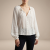 FJØRNA women's summer blouse with V-neck, long lace sleeves, and ruffle details, shown from the front.