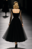 Black maxi dress for women by FJØRNA, flowing long dress with sleeveless design and elegant style, suitable for casual or formal wear.