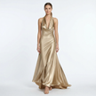 Gold women's halter neck satin maxi dress by FJØRNA with flowing fabric and elegant design, perfect for formal occasions.
