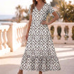 Gray Ruffled Hem A-Line Maxi Dress for women by FJØRNA, featuring flowing fabric and elegant ruffle details.