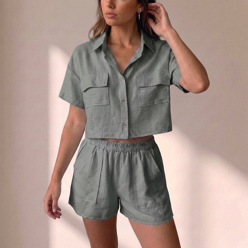 FJØRNA relaxed 2-piece shorts set in gray textured woven fabric with collared top and matching shorts, casual and lightweight style.