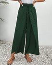 Green FJØRNA women's lightweight summer trousers with wide-leg, breathable, flowy design, perfect for warm weather.