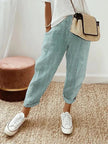 FJØRNA Holly™ striped green pants with a relaxed fit and bold pattern, styled with a casual top and sneakers for a trendy look.