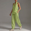 Green FJØRNA lightweight two-piece halter V-neck suit with wide-leg trousers, styled for a relaxed summer look.