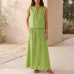 Green women's two-piece co-ord set by FJØRNA featuring a V-neck top with pockets and matching pants.