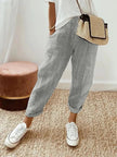 FJØRNA Holly™ striped grey pants with a relaxed fit, featuring horizontal grey and white stripes and an elastic waistband.