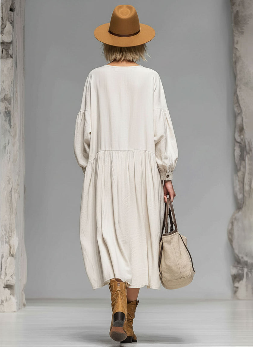 FJØRNA cotton button-front midi dress for women, showcasing a stylish, flowy dress with a buttoned bodice and midi length.