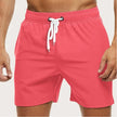 Men's FJØRNA quick-dry swim shorts with elastic waist, featuring a lightweight, breathable design for comfortable beach wear.