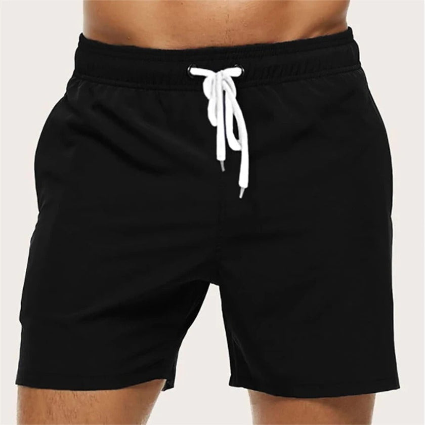 Men's quick-dry swim shorts by FJØRNA with elastic waistband, perfect for beach and pool swimming, shown in a relaxed fit.