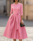 FJØRNA crew-neck midi dress for women, soft fabric, knee-length, with a simple, elegant design and long sleeves.