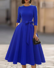 FJØRNA crew-neck midi dress for women, stylish knee-length dress with a fitted waist and soft fabric in a solid color.