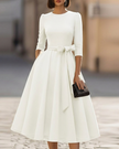 FJØRNA crew-neck midi dress for women, stylish and comfortable knee-length dress with a fitted top and flowing skirt.