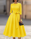 FJØRNA crew-neck midi dress for women, shown in soft fabric, knee-length cut, with a fitted waist and short sleeves.