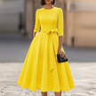 FJØRNA crew-neck midi dress for women, featuring a sleek, fitted design with long sleeves and a midi length in soft fabric.