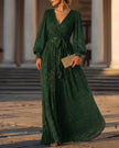 FJØRNA shimmering long-sleeve V-neck wrap evening gown, elegant maxi dress with a flowing silhouette and subtle shimmer fabric.