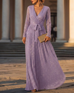 FJØRNA shimmering long-sleeve V-neck wrap evening gown, elegant maxi dress with sleeves, in a flowing, shimmering fabric.