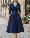 FJØRNA satin midi dress with trench collar, waist-defining band, long sleeves, and elegant wrap design.
