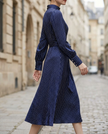 FJØRNA high-neck pinstripe midi dress with structured waist, showcasing a tailored silhouette and classic pattern.