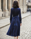 FJØRNA high-neck pinstripe midi dress with structured waist, stylish women's dress featuring a sophisticated silhouette.