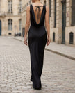 FJØRNA sleeveless draped cowl neck midi dress for women, featuring a flowing silhouette and elegant design in a neutral fabric.