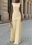 FJØRNA elegant sleeveless pleated maxi dress for women, flowing fabric with a fitted bodice and full-length skirt.
