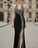 FJØRNA sleeveless evening gown with contrast panels, sculpted design, and elegant maxi dress style with sleeves.