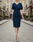 FJØRNA elegant embellished cape-overlay V-neck midi dress for women, featuring intricate detailing and a flowing silhouette.