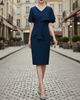 FJØRNA elegant embellished cape-overlay V-neck midi dress for women, featuring intricate detailing and a flowing silhouette.