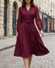 FJØRNA elegant wrap midi dress for women with sheer sleeves, showcasing a flowing silhouette and sophisticated design.