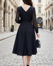 FJØRNA elegant wrap midi dress for women with sheer sleeves, featuring a sleek, sophisticated design and flowing fabric.