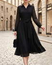 FJØRNA elegant wrap midi dress for women with sheer sleeves, showcasing a sophisticated design and flowing fabric.