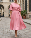 FJØRNA radiant one-shoulder midi dress with waist tie and flared skirt, perfect for elegant women's occasion wear.